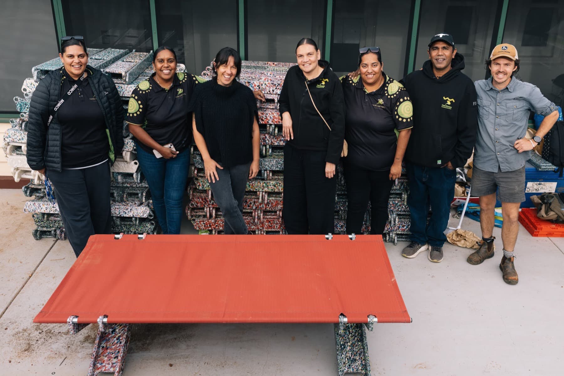 The Oonchiumpa team with a finished red Stretch Bed in Alice Springs