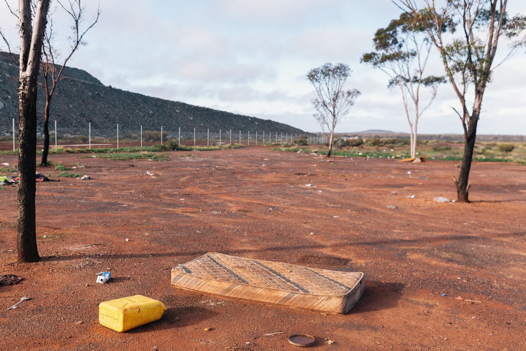A failed mattress dumped on red dirt near Kalgoorlie