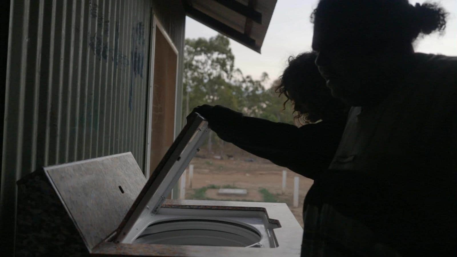 Opening the washing machine lid at dusk, Maningrida