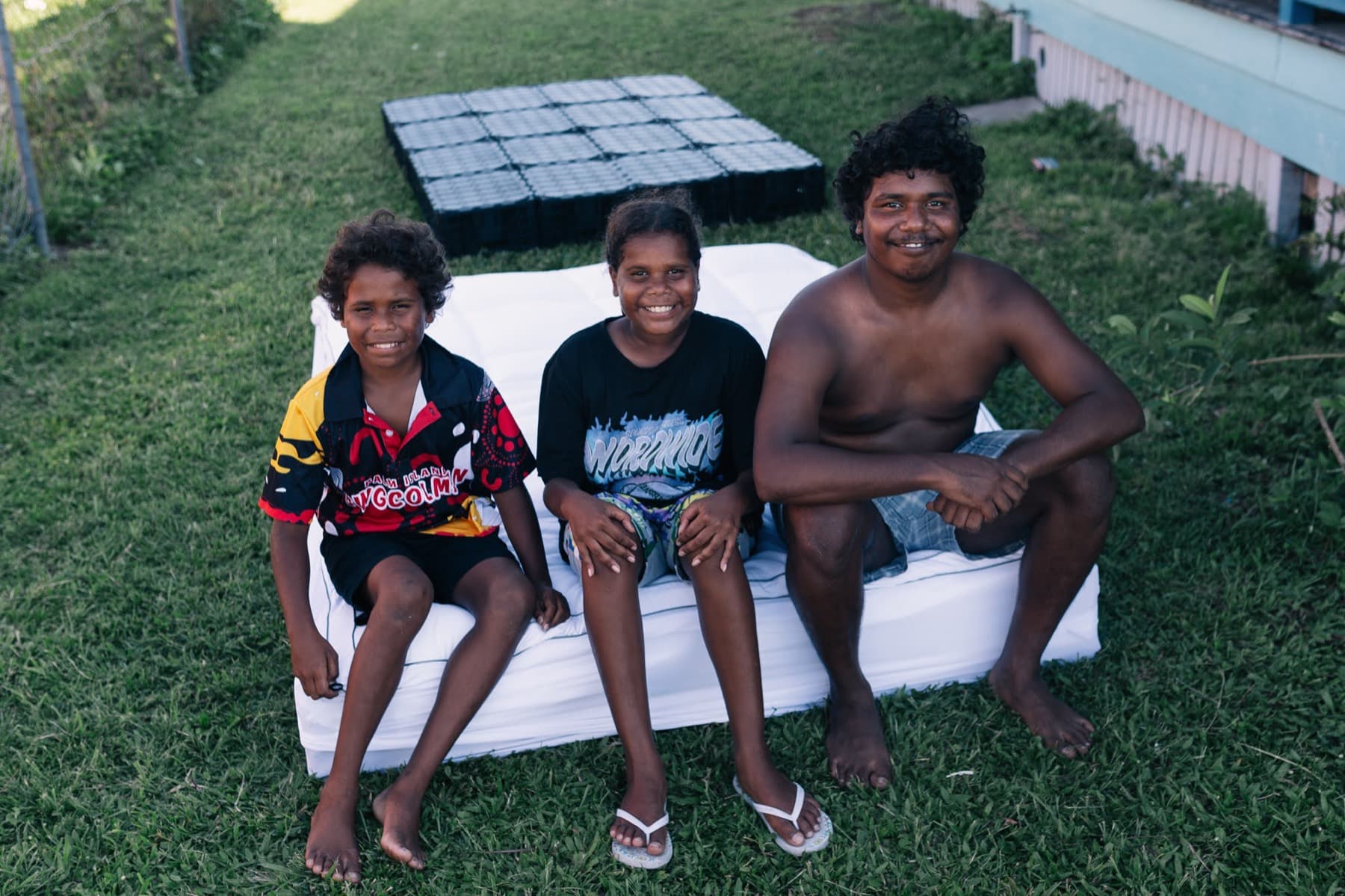 Kids with a new mattress on Palm Island