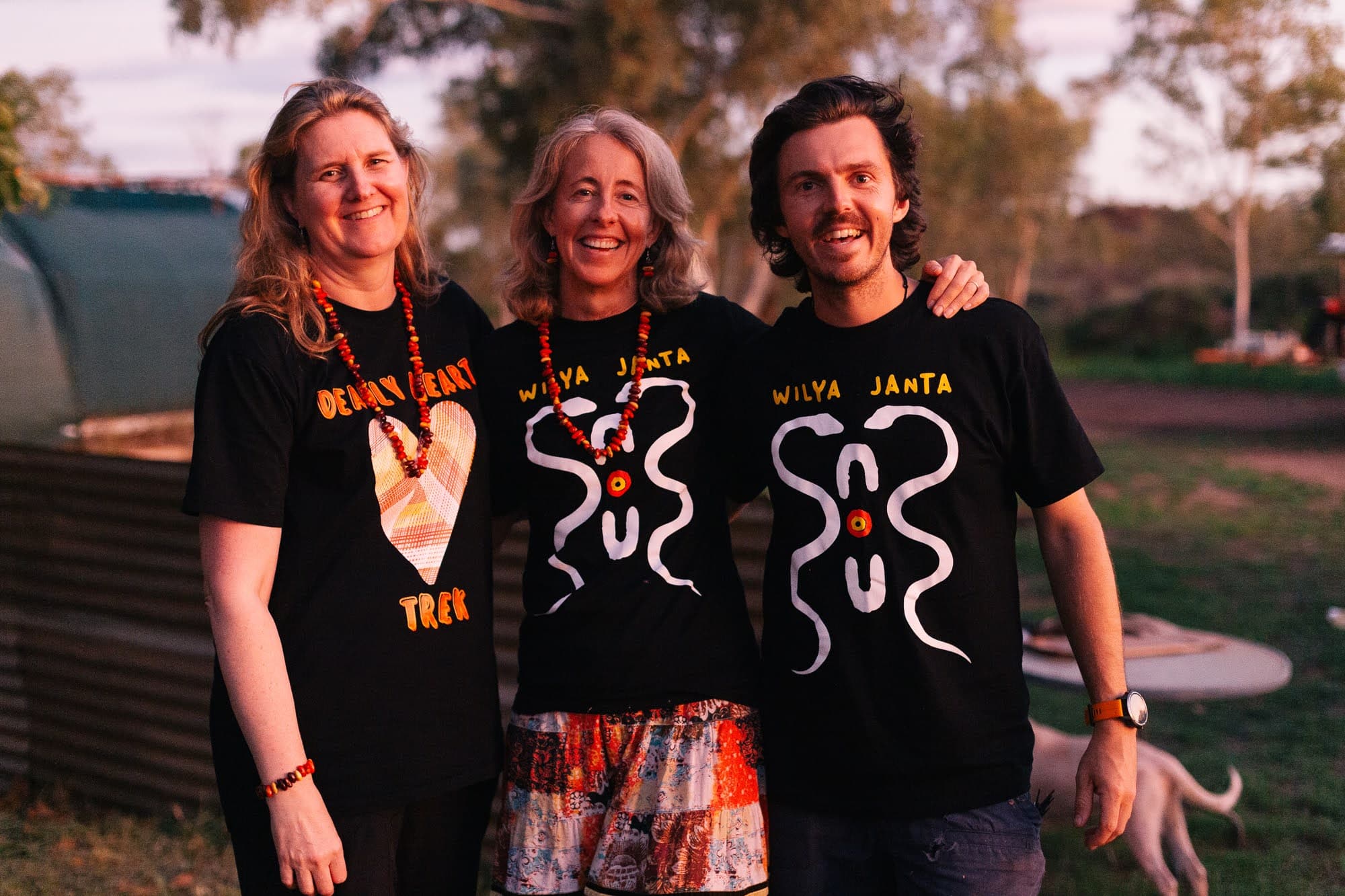 Sally Grimsley-Ballard and Georgina Byron AM of the Snow Foundation with Nic Marchesi, in Wilya Janta shirts at Tennant Creek