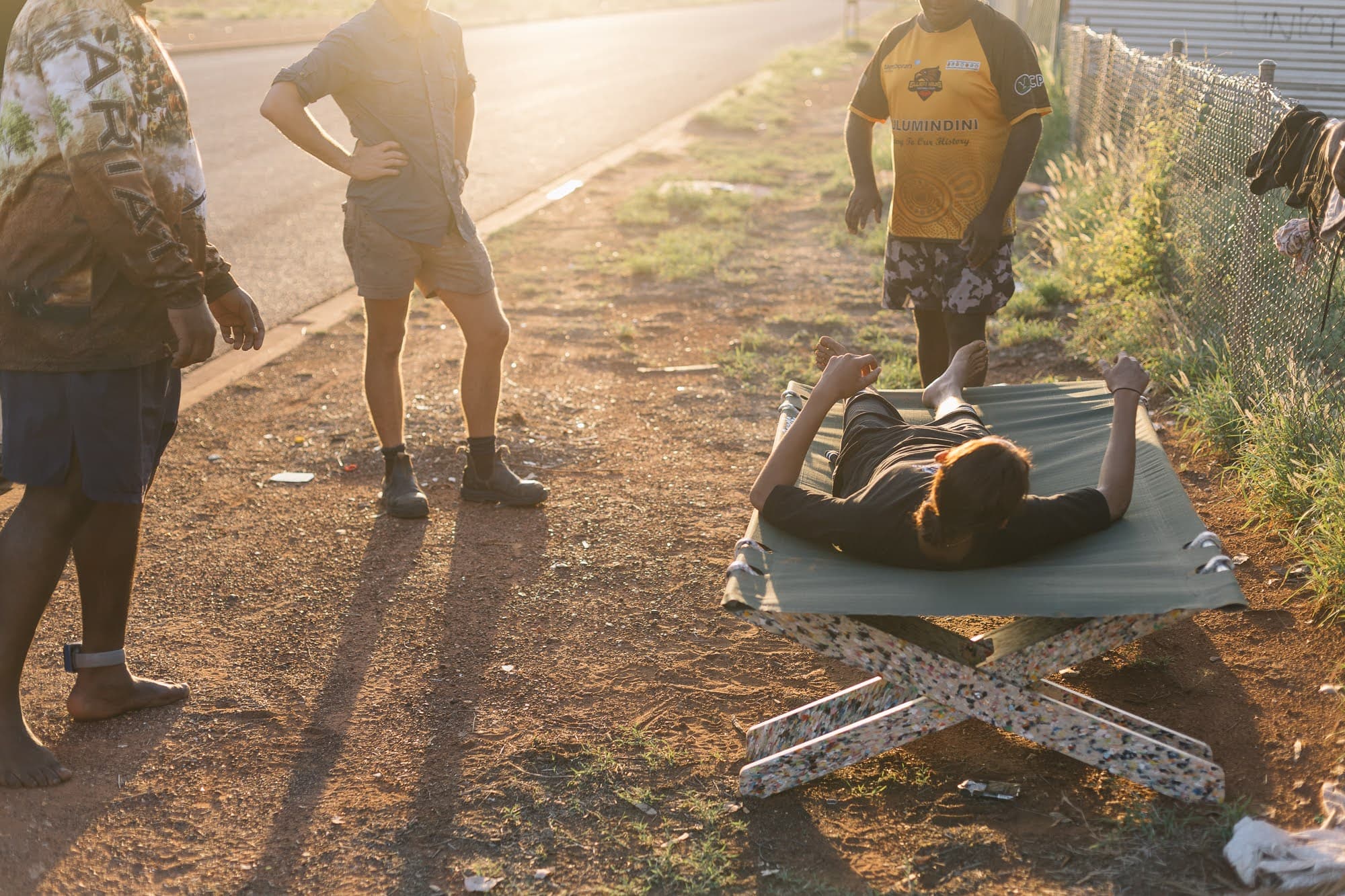Community members testing a Stretch Bed at golden hour.
