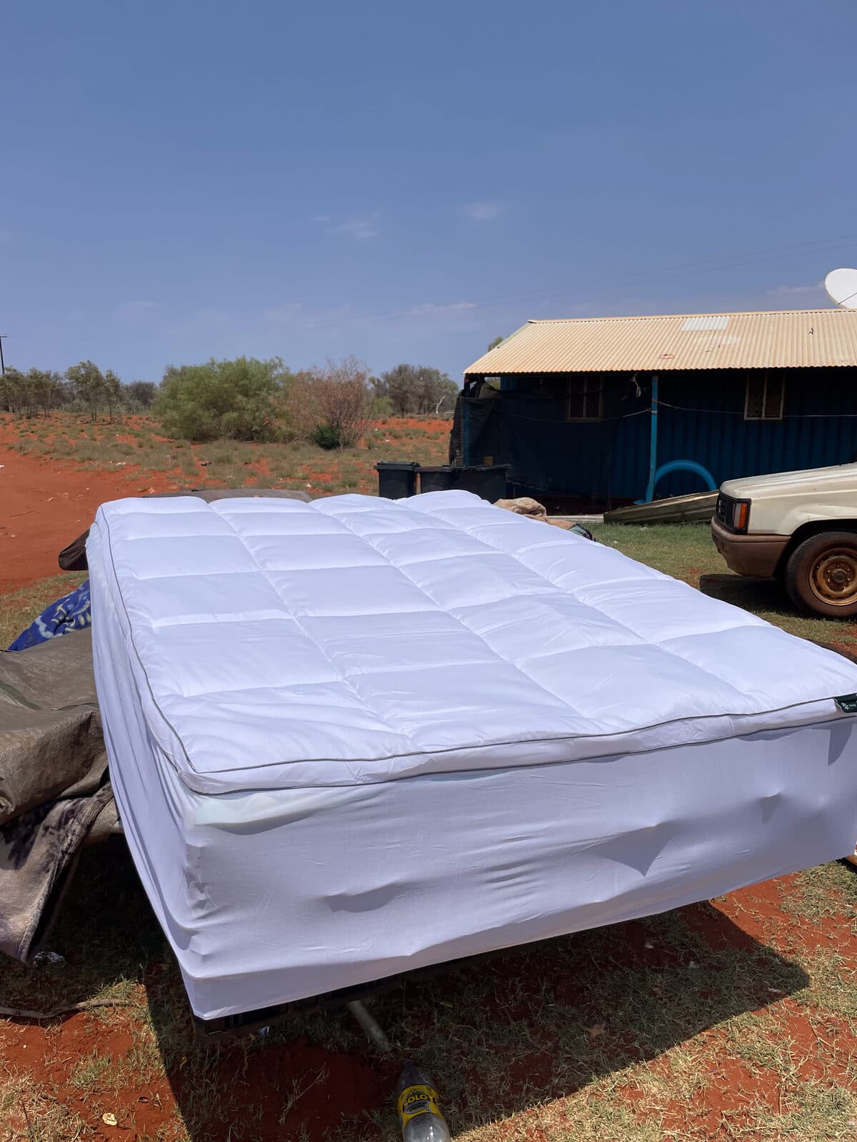 A finished bed on Country beside a remote home