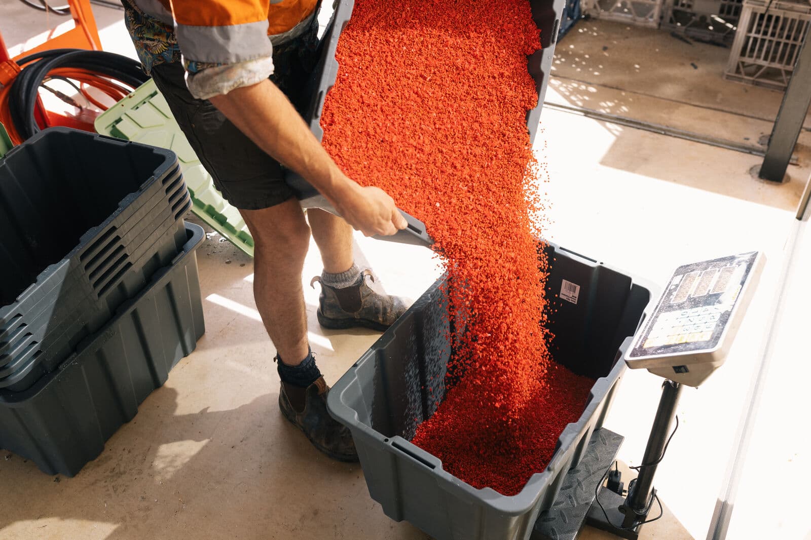 Recycled plastic flake poured for pressing
