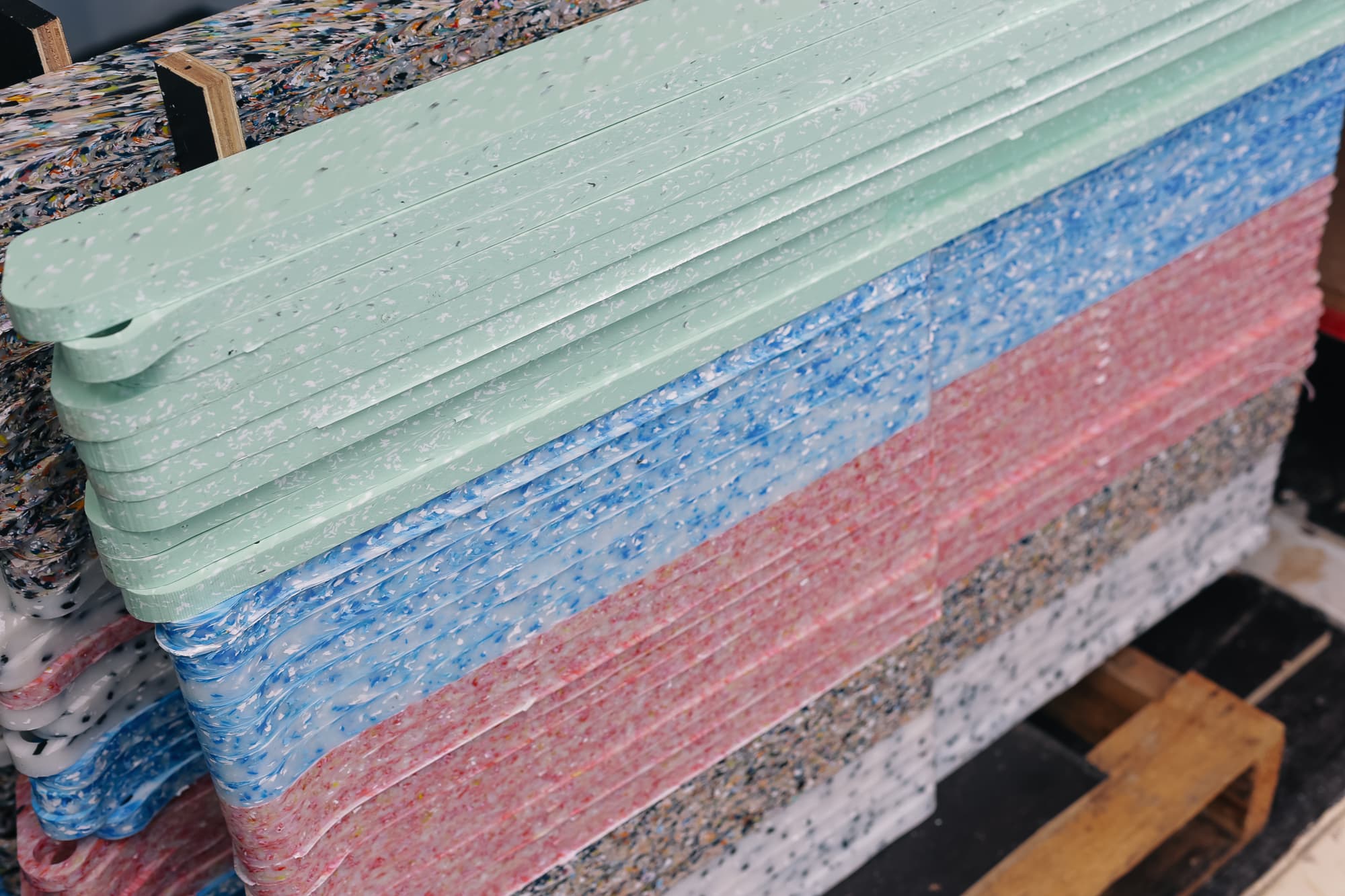 Stack of pressed recycled plastic legs in multiple colours
