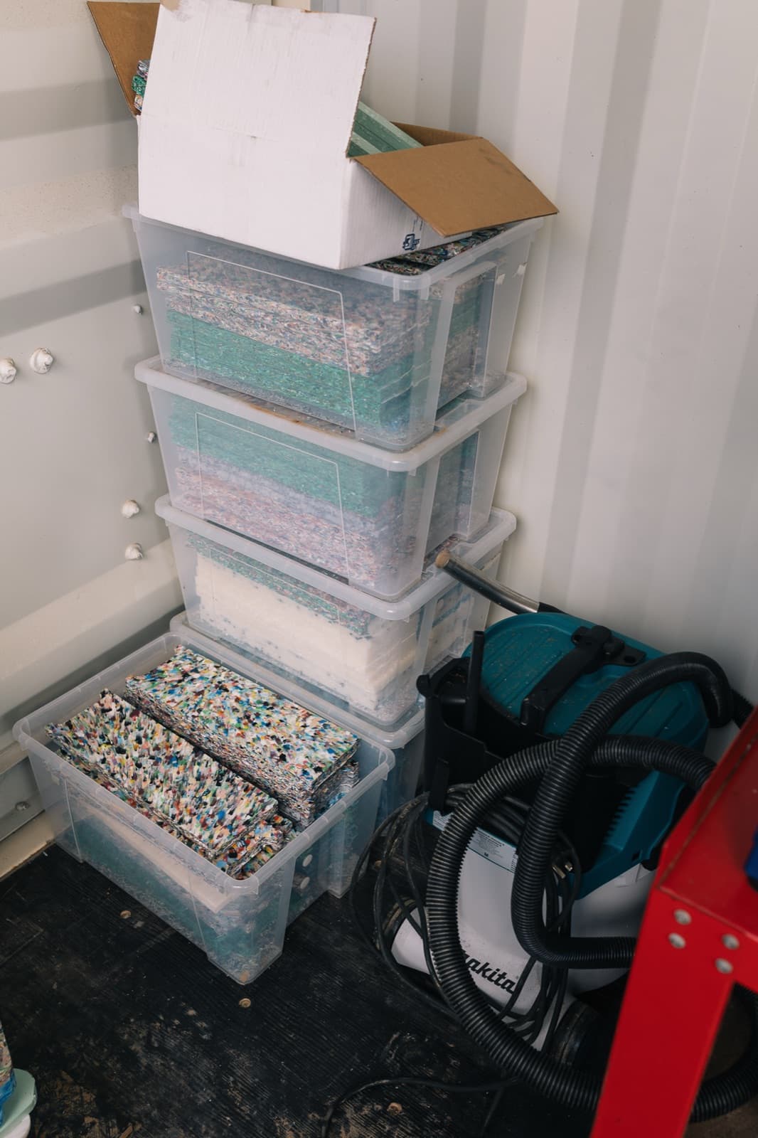 Tubs of sorted recycled HDPE plastic ready for shredding