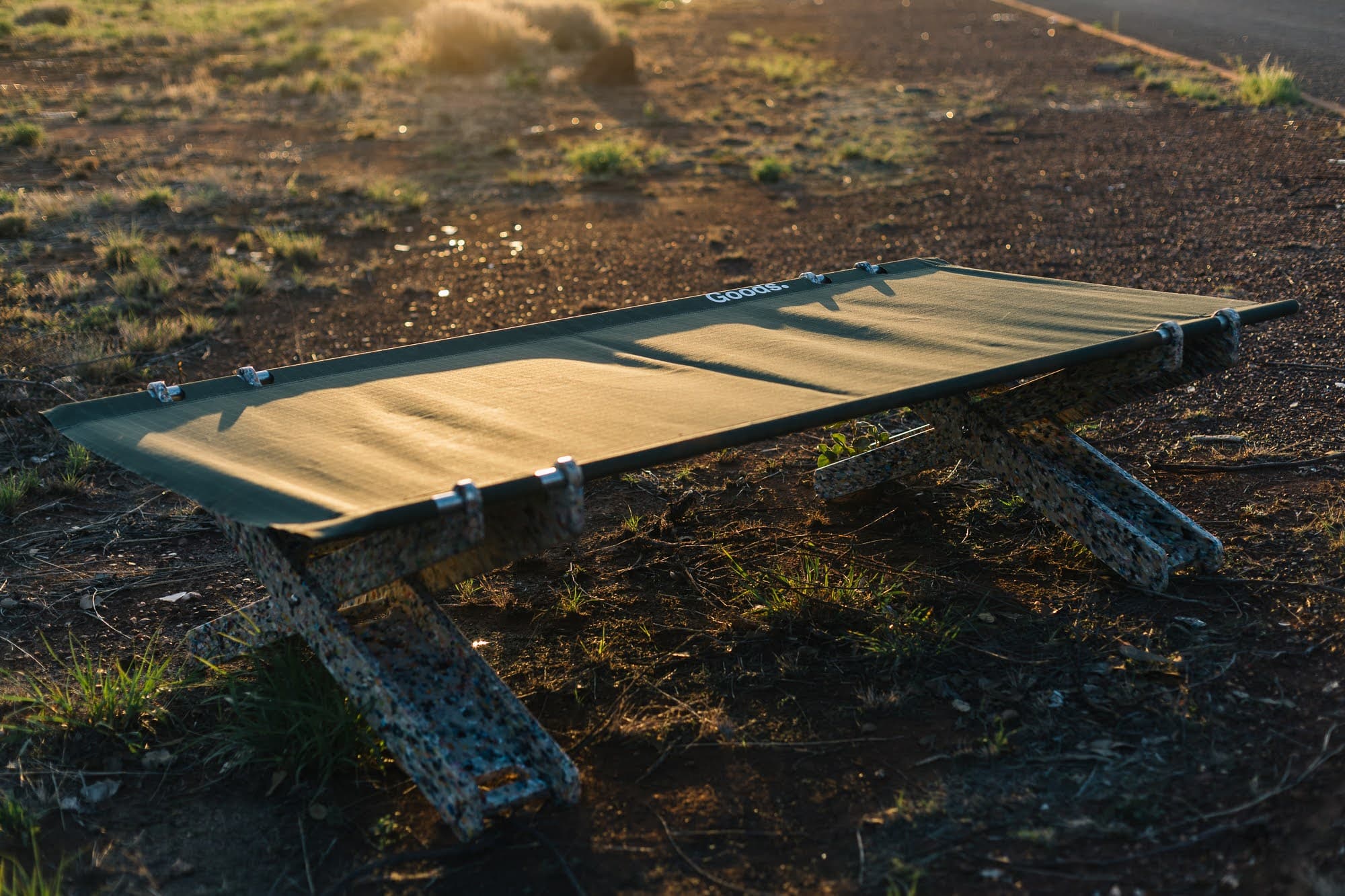 Stretch Bed alone at golden hour showing recycled plastic X-legs