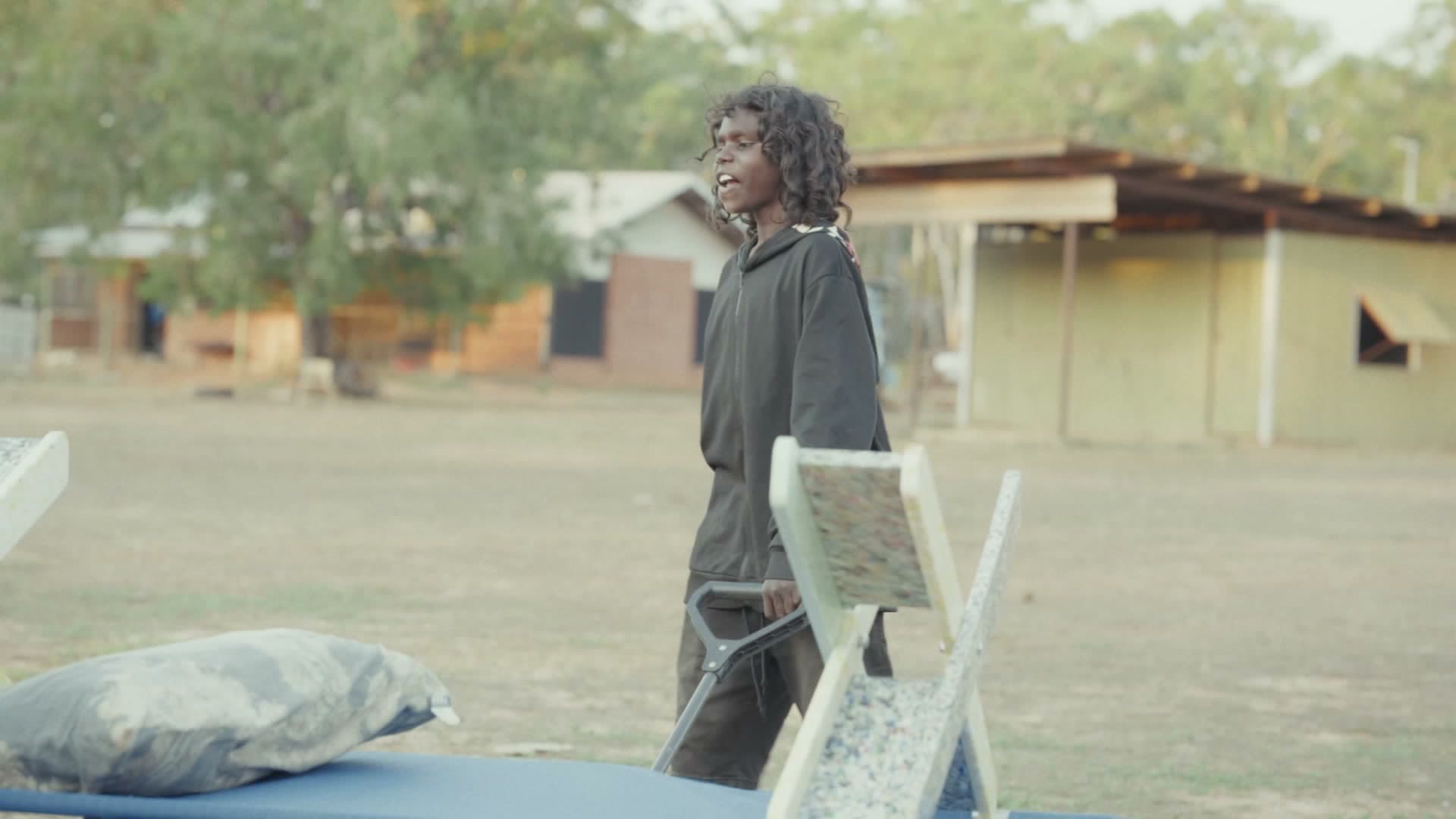 Carrying a Stretch Bed through the community at Gamardi